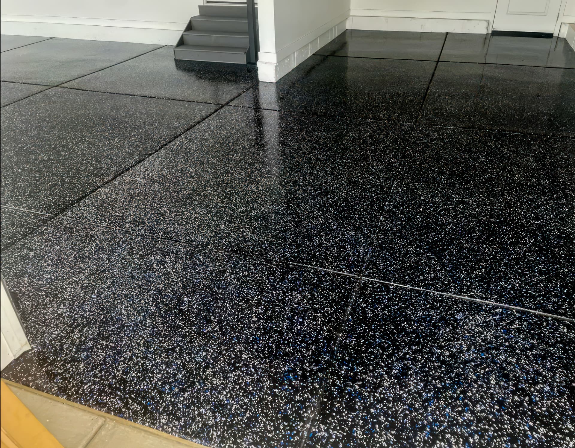 Black and white flake garage floor coating with a high-gloss finish in Utah.