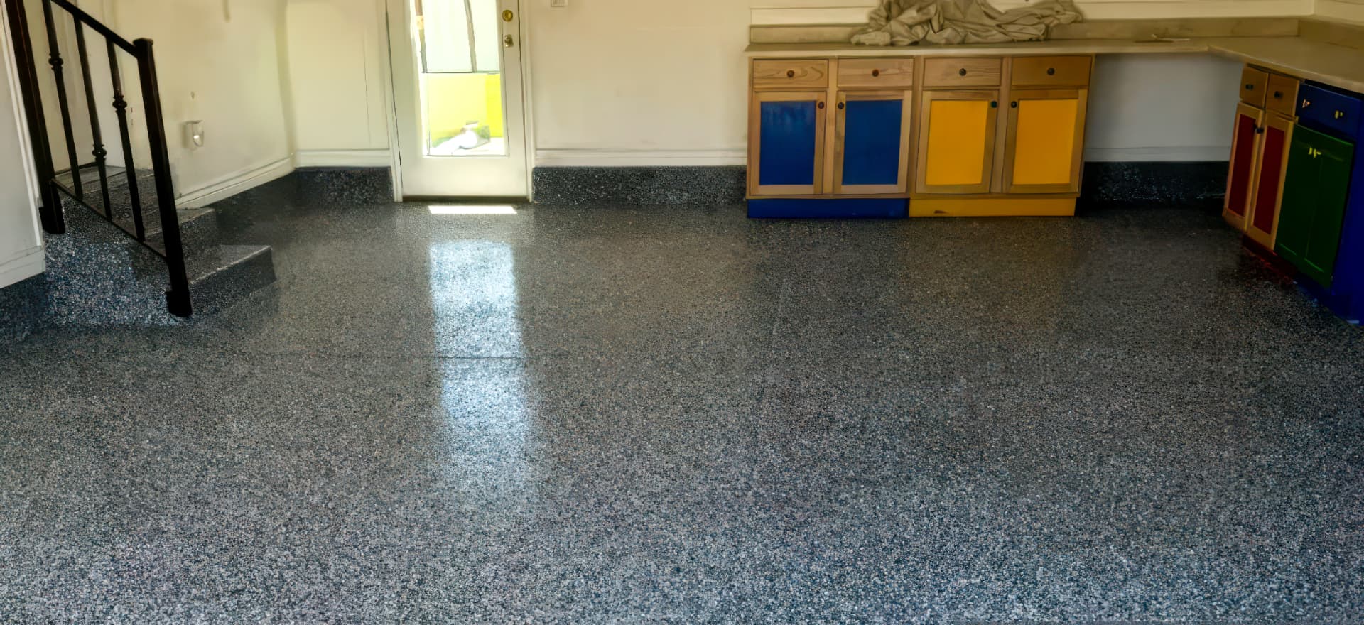 The same garage after a gray polyaspartic flake floor coating was installed.