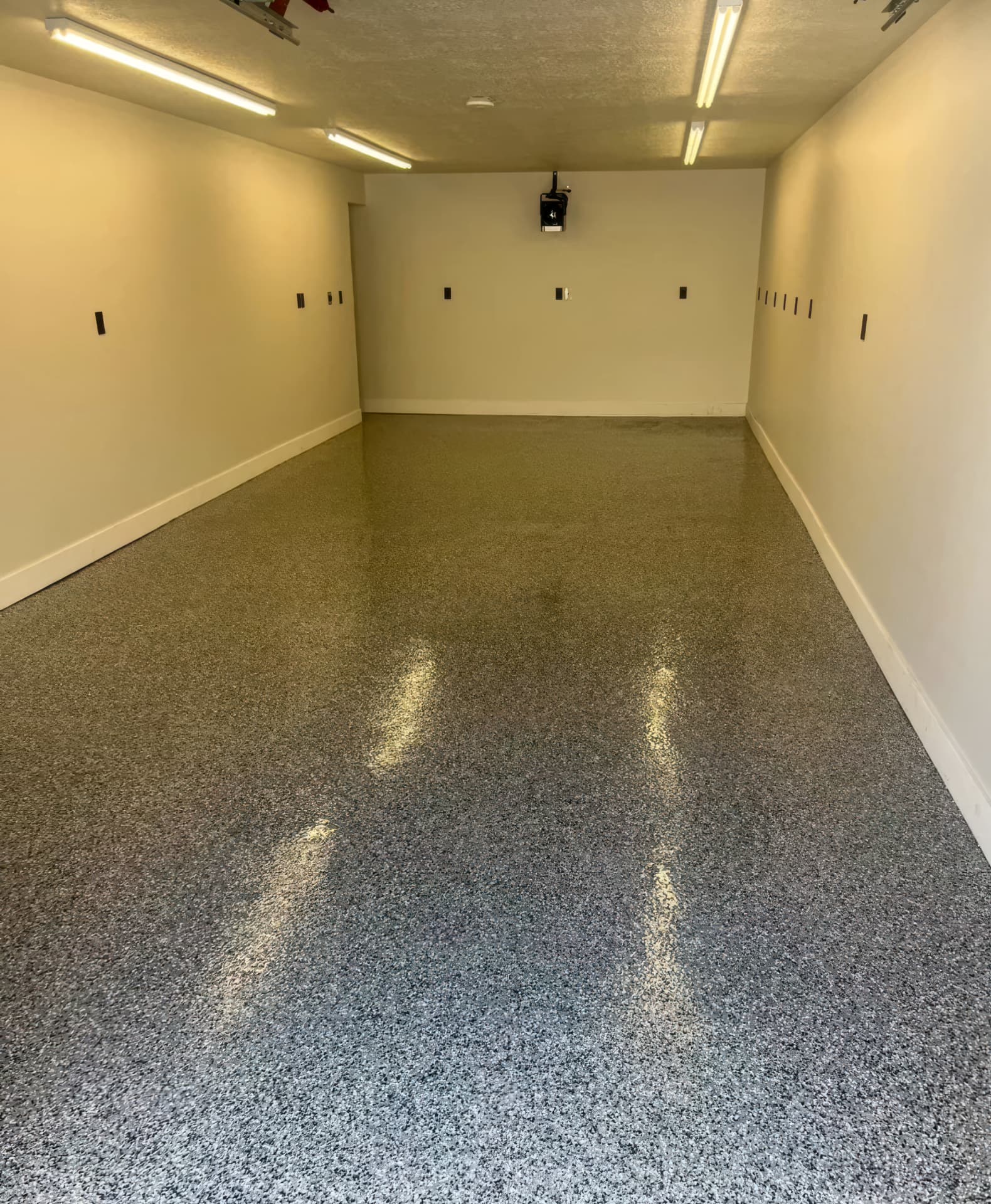 Gray and tan polyaspartic flake garage floor coating in a Utah County home.